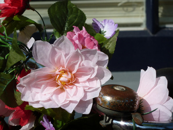 Een bloemstuuur met plastic bloemen in t'zonnetje